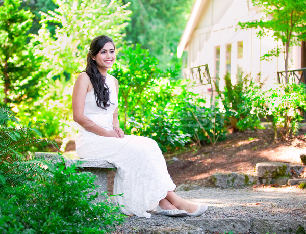 Beautiful biracial bride in white lace wedding dress sitting on  Stock photo © jarenwicklund