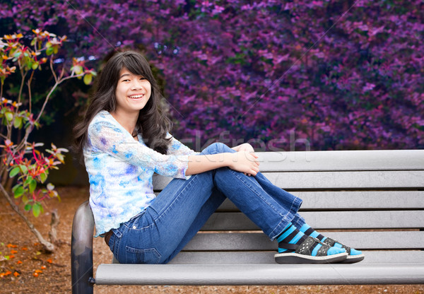 Young preteen girl sitting on park bench outdoors Stock photo © jarenwicklund