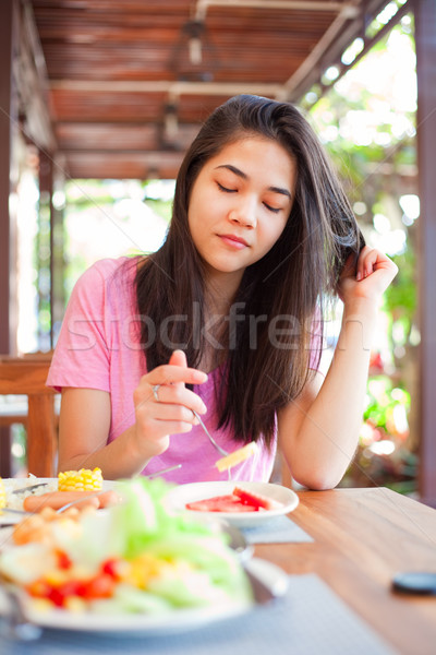 Teen girl eating breakfast on outdoor veranda Stock photo © jarenwicklund