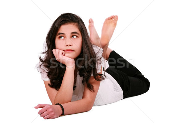 Stock photo: Beautiful biracial teen girl lying on floor relaxing, looking up