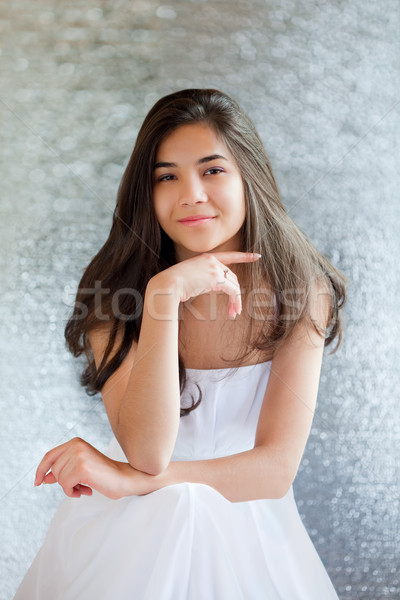 Beautiful biracial teen girl in white dress sitting, thinking Stock photo © jarenwicklund
