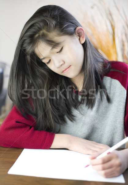 Ten year old girl writing or drawing on paper Stock photo © jarenwicklund