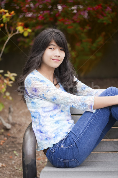 Young preteen girl sitting on park bench outdoors Stock photo © jarenwicklund