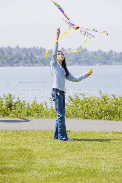 Biracial asian girl flying kite by the lake Stock photo © jarenwicklund