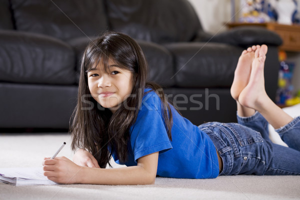 Stock photo: Little girl doing her homework