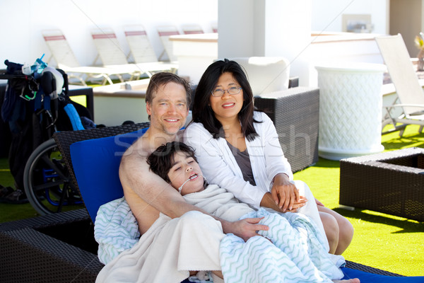 Father and mother with disabled son on blue lounger off side of  Stock photo © jarenwicklund