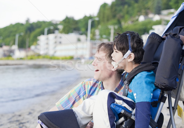 Father enjoying  beach with disabled son Stock photo © jarenwicklund