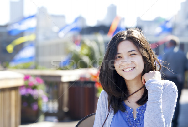 Young biracial teen girl smiling outdoors, sunny background Stock photo © jarenwicklund