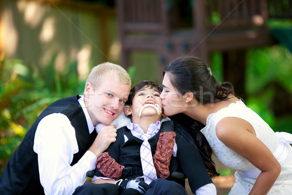 Biracial bride kissing her little brother on her wedding day. Ch Stock photo © jarenwicklund