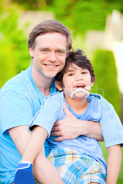 Jóképű apa tart mosolyog mozgássérült fiú Stock fotó © jarenwicklund