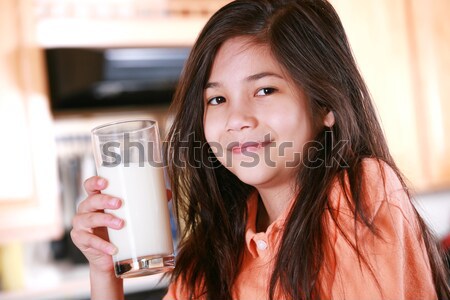 Beautiful young biracial girl drinking milk Stock photo © jarenwicklund
