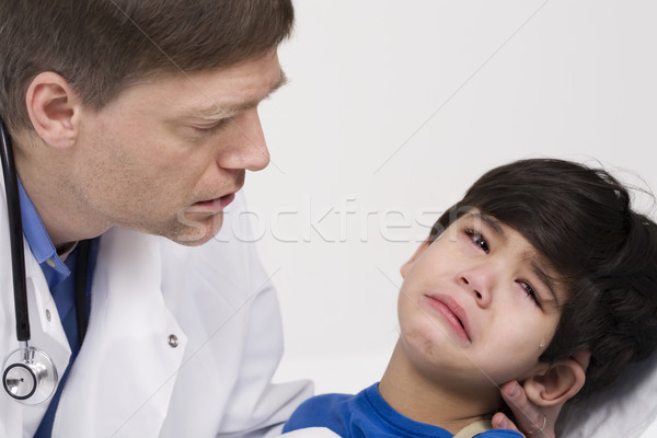Male doctor comforting disabled  toddler patient. Child is five years old Stock photo © jarenwicklund