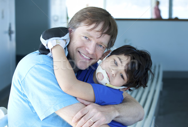 Disabled boy giving father a big hug Stock photo © jarenwicklund