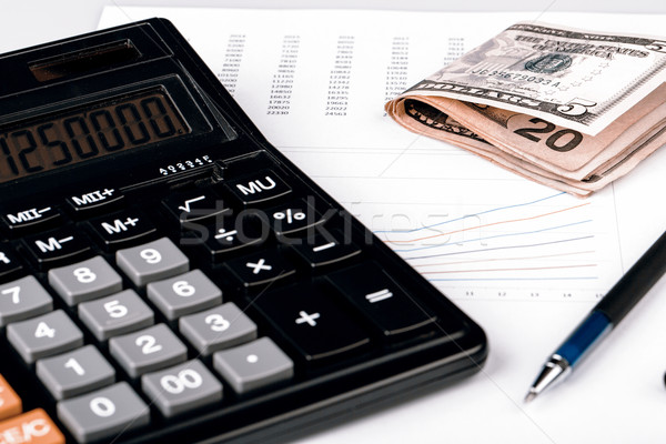 Business Charts with calculator, money and pen Stock photo © jarin13