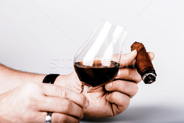 Old brandy in glass and cigar in male hand on white background Stock photo © jarin13