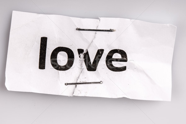 'Love' word written on torn and stapled paper Stock photo © jarin13