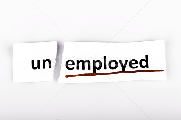 The word unemployed changed to employed on torn paper Stock photo © jarin13