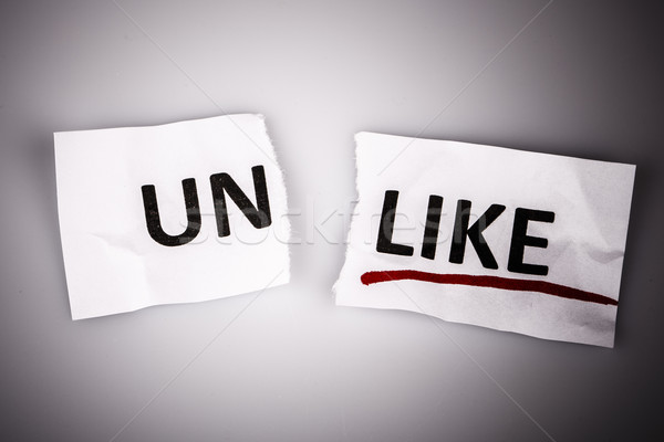 The word unlike changed to like on torn paper Stock photo © jarin13