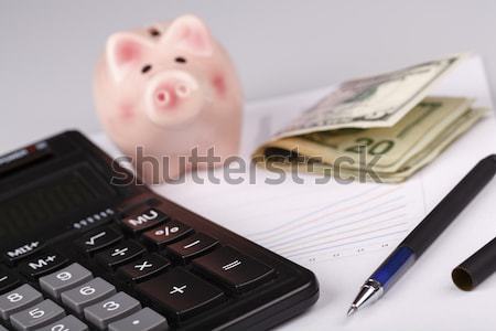 Stock photo: Business Charts with calculator, money, piggy box and pen