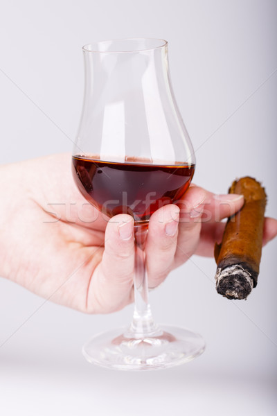 Old brandy in glass and cigar in male hand on white background Stock photo © jarin13