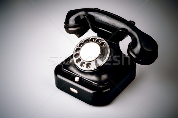 Old black phone with dust and scratches on white background Stock photo © jarin13