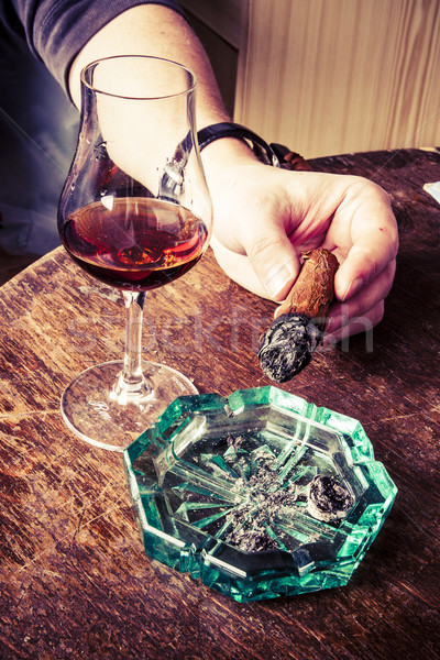 cigar in man hand with glass of alcohol Stock photo © jarin13