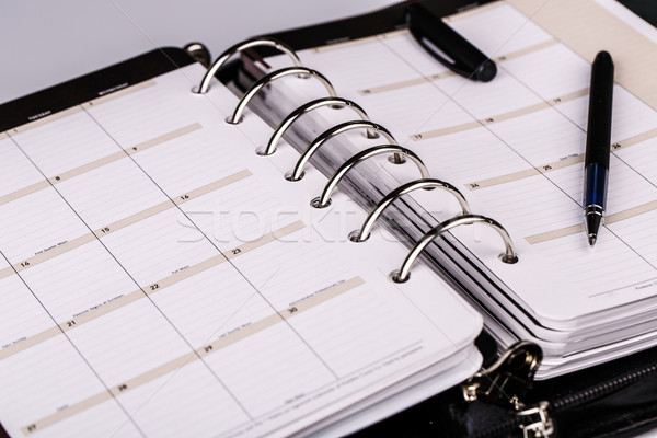 Personal organizer or planner with pen on white background Stock photo © jarin13