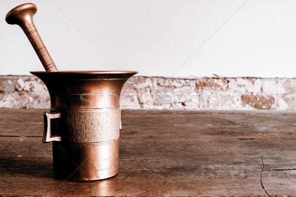 Old bronze mortar with pestle on wootden table Stock photo © jarin13