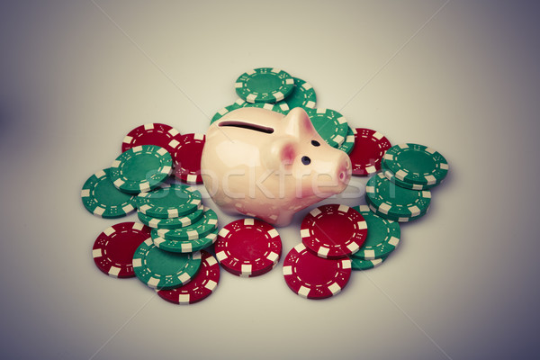 pig money box with casino chips over white Stock photo © jarin13