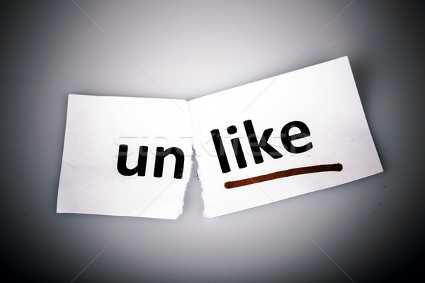The word unlike changed to like on torn paper Stock photo © jarin13