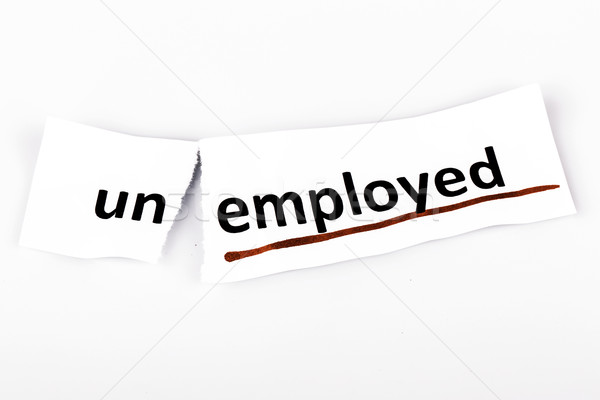 The word unemployed changed to employed on torn paper Stock photo © jarin13