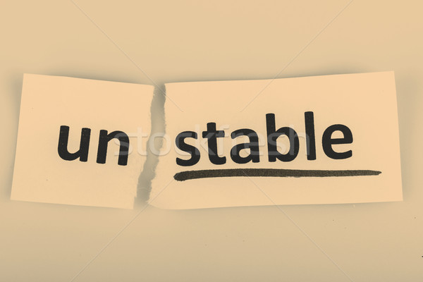 The word unstable changed to stable on torn paper Stock photo © jarin13