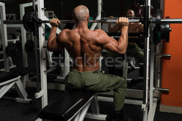 Saludable hombre maduro ejercicio hombro gimnasio oscuro Foto stock © Jasminko