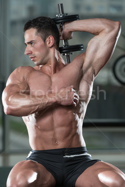 Bodybuilder Exercising Triceps With Dumbbells Stock photo © Jasminko
