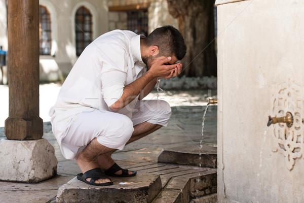 Stock photo: Islamic Religious Rite Ceremony Of Ablution Face Washing