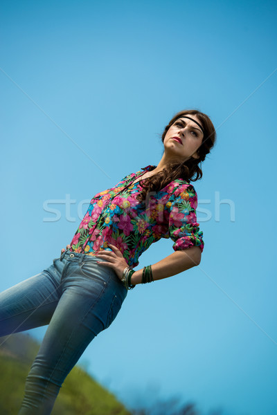 beautiful woman in jeans standing on the grass Stock photo © Jasminko