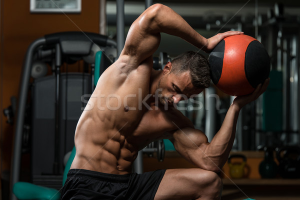 Muscular Man Exercise With Medical Ball Stock photo © Jasminko