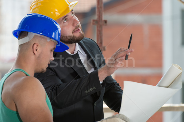 Businessman Showing Industrial Worker At Construction Stock photo © Jasminko