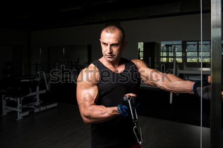 Stock photo: Young Muscular Man Lifting Weights