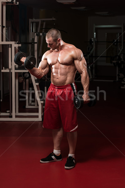 Muscular Man Doing Heavy Weight Exercise For Biceps Stock photo © Jasminko