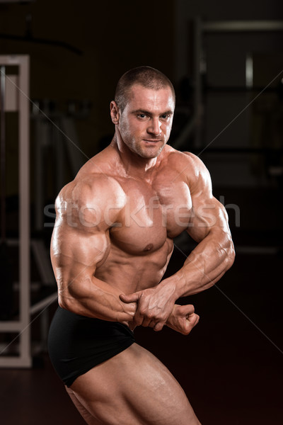 Young Bodybuilder Flexing Muscles Stock photo © Jasminko