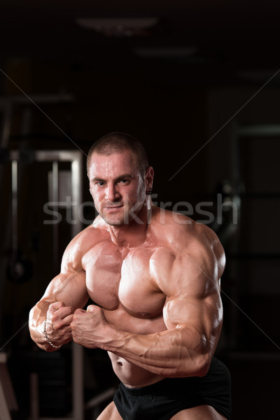 Young Bodybuilder Flexing Muscles Stock photo © Jasminko