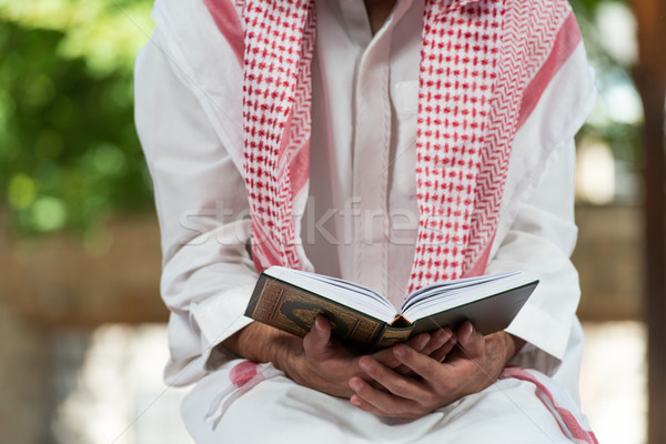 Muslim Man In Dishdasha Is Reading The Quran Stock photo © Jasminko