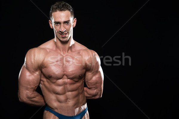 Young Bodybuilder Flexing Muscles Isolate On Black Blackground Stock photo © Jasminko