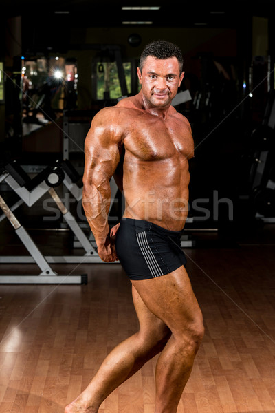 Stock photo: muscular bodybuilder showing his side triceps