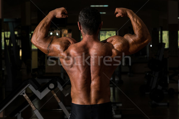 muscular bodybuilder showing his back double biceps Stock photo © Jasminko