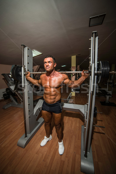 bodybuilder doing squat with barbell Stock photo © Jasminko