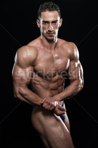 Ayakta güçlü genç vücut geliştirmeci kaslar Stok fotoğraf © Jasminko