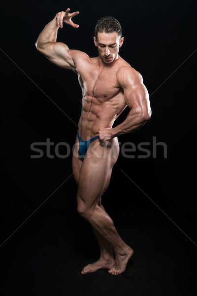 Young Bodybuilder Flexing Muscles Isolate On Black Blackground Stock photo © Jasminko
