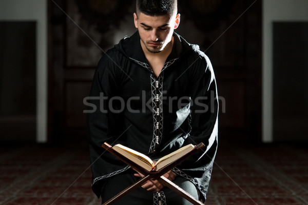 Muslim Man In Dishdasha Is Reading The Quran Stock photo © Jasminko